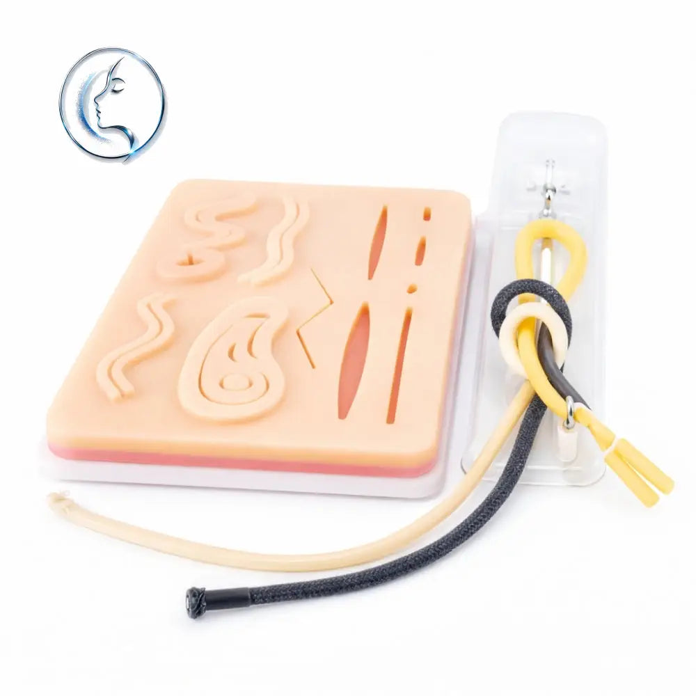 Peach-colored silicone medical practice pad with internal organs and tubing for knot-tying training kit use